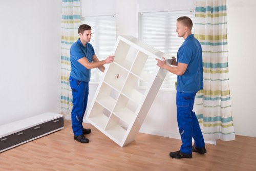 Organized long-term storage unit with labeled boxes and covered furniture